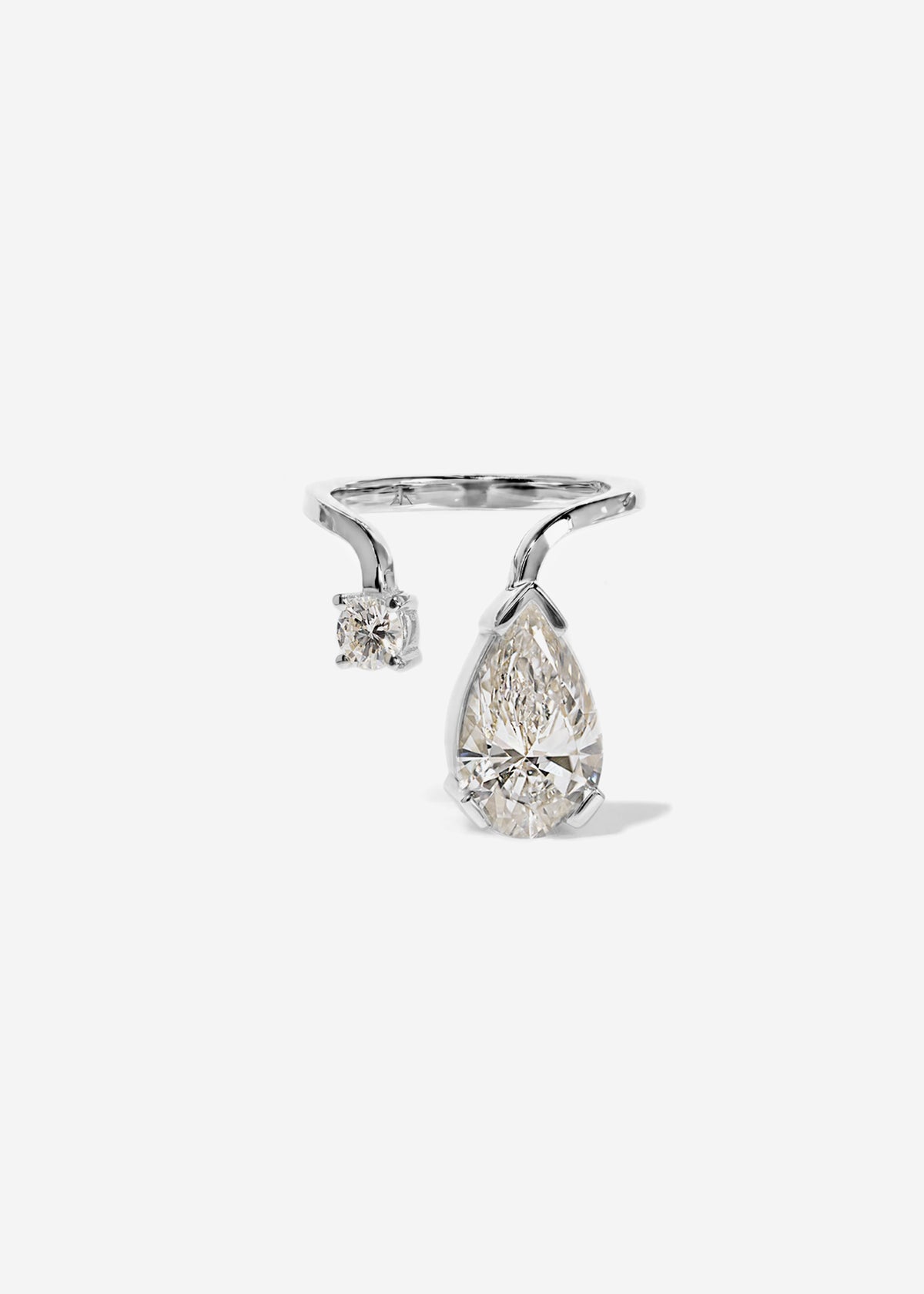 A 18k white gold ring featuring a large pear-cut diamond drop and a smaller round diamond accent on a curved band.