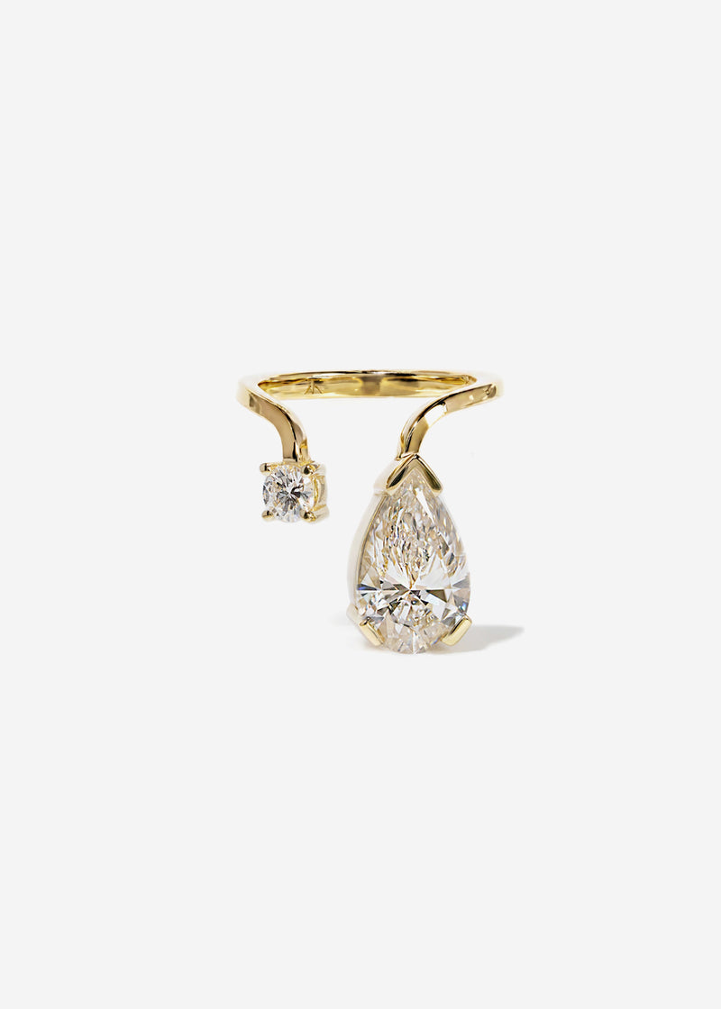 A 18k yellow gold ring featuring a large pear-cut diamond drop and a smaller round diamond accent on a curved band.