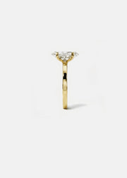 A 18k yellow gold solitaire engagement ring featuring a oval-cut diamond center stone, shown from a side profile view against a clean white background.