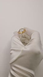 A video showcasing the 18k yellow gold ring featuring a central asscher-cut diamond flanked by two baguette-cut side stones