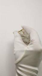 video showcasing a 18k yellow gold open wrap ring featuring a pear-cut diamond and a pavé diamonds along the band.
