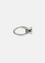 side view of a 18k white gold ring with a east west emerald cut diamond as the center stone