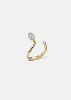 A 18k yellow gold open wrap ring featuring a pear-cut diamond and a pavé diamonds along the band.